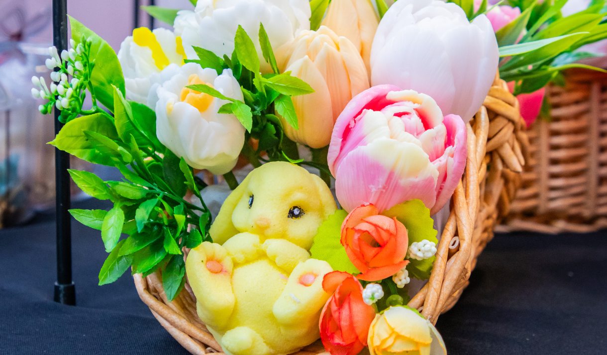 A candle in the shape of an Easter bunny with flowers at Greenwich Market